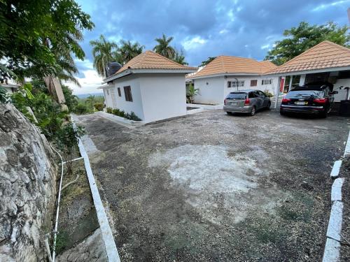 a parking lot in front of a house at The Lodge @ Peaceful Palms in Montego Bay