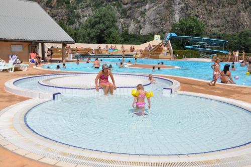 a group of people in a swimming pool at Villa Lutel in Le Bourg-dʼOisans