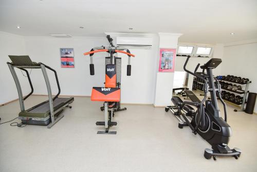a gym with two treadmills and two exercise bikes at Villa Rana The Royal Links Sarigerme in Ortaca