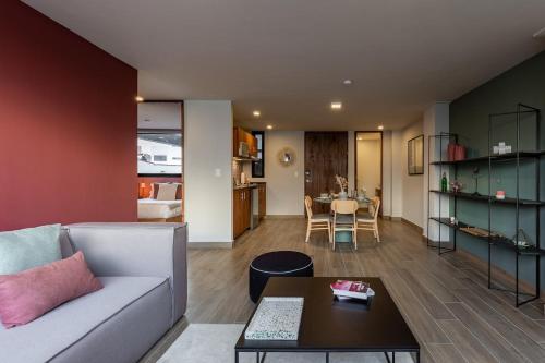a living room with a couch and a table at Roma Norte Trendy Apartments by VIATO in Mexico City