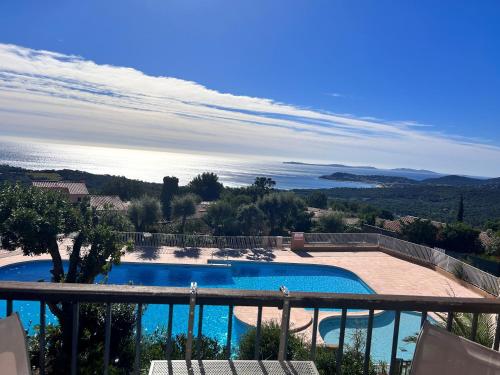 a view of a swimming pool from a balcony at STUDIO POOL HOUSE MDT 2 ETOILES VUE MER PANORAMIQUE AMAZING SEA VIEW WIFI LINGE LINEN INCLUT AIRCONDITIOn in La Croix-Valmer