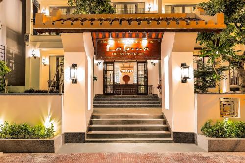 a lobby of a hotel with stairs leading to the entrance at Laluna Hoi An Riverside Hotel & Spa in Hoi An
