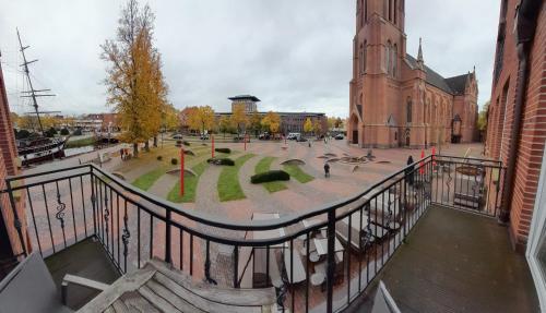 a view from a balcony of a church with a courtyard at Arkadenhaus - Hotel Freiherr von Schwarzenberg in Papenburg