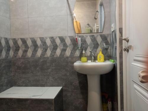 a bathroom with a sink and a shower at Malacia apartments in Yerevan