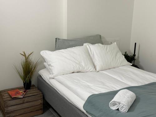 a bed with white sheets and pillows on it at A Place To Stay Stavanger, apartment 1 in Stavanger