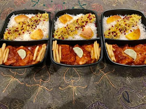 three containers filled with rice and different types of food at Chez Roya in Zaventem