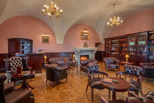 a large room with chairs and a fireplace at Galicia Nueva, castle hotel in Lučenec