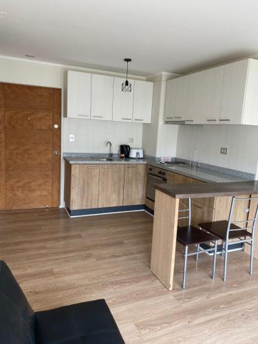 a kitchen with white cabinets and a counter top at Brisas in Talcahuano