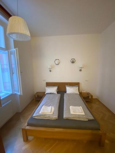 a bedroom with a bed with two pillows on it at Cosy central apartment in Žižkov in Prague