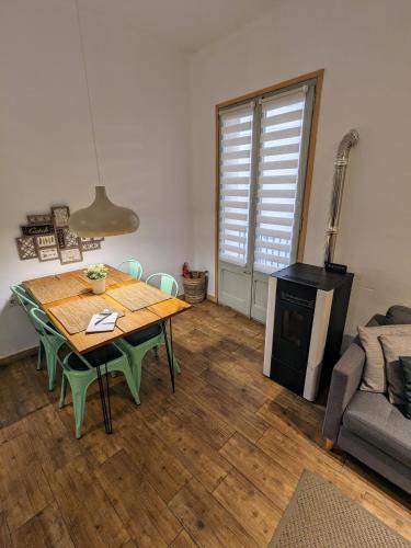 a living room with a wooden table and a stove at Precioso y acogedor piso en la Seu de Urgell in La Seu d'Urgell