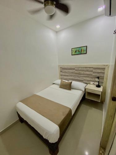 a bedroom with a bed and a ceiling fan at Hotel La Magdalena in Cartagena de Indias