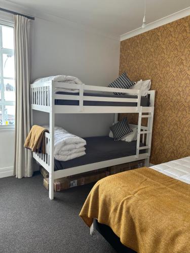 a bedroom with two bunk beds in a room at Old Bank Apartment in Motueka
