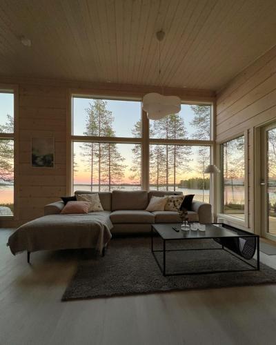 a living room with a couch and a table at Villa Kuulas in Sääskilahti