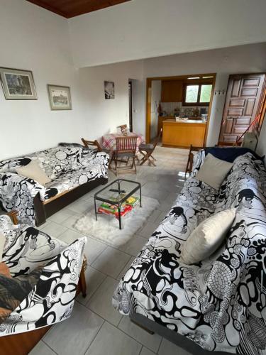a living room with two couches and a table at My Sweet Home in Tríkala