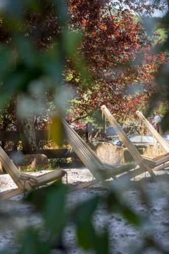 a group of wooden swings in a park at Hotel Erasmus - Mein Genuss- und Wellnesshotel in Trassem