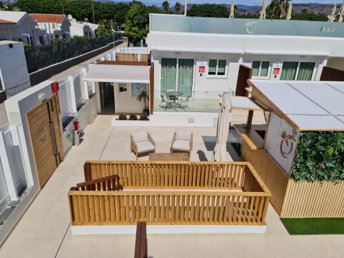 a view from the roof of a building with benches at MAR BIANCO - Gay Men Only in Maspalomas