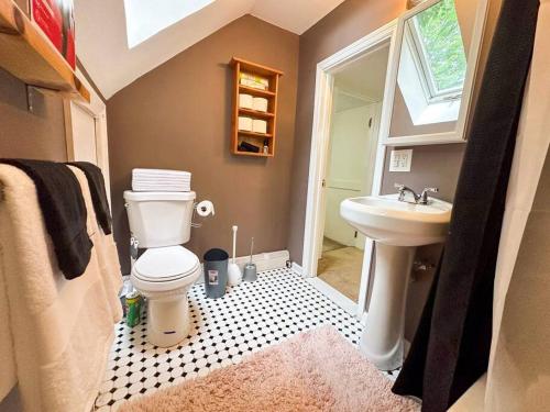 a bathroom with a toilet and a sink at GREAT VALUE! 7 Beds, W/D, & Parking! in Albany