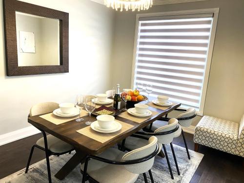 a dining room with a table with chairs and a mirror at iResidence in Toronto - Fantastic Vacation Home with Breakfast in Toronto