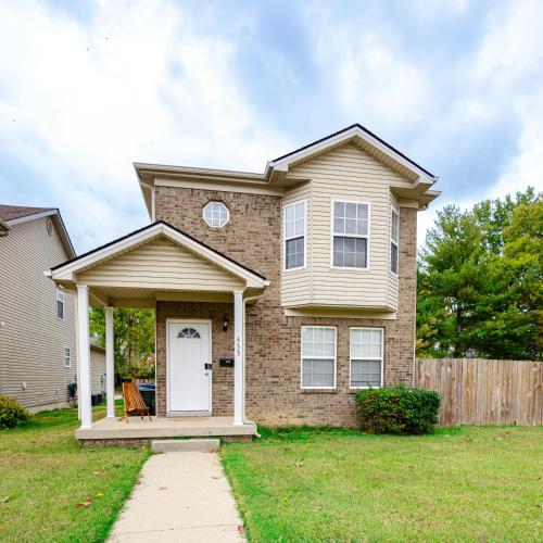 a house with a white door and a fence at LUX - Downtown Oasis - Pool Table! Free Parking! in Lexington