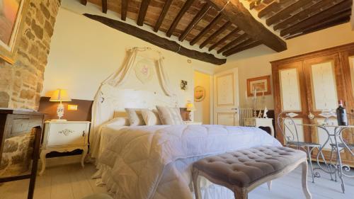 a bedroom with a large bed with a canopy at Residenza Teatro Antico in Todi