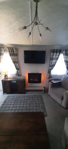 a living room with a couch and a tv at Lapwing 5 in Scarborough