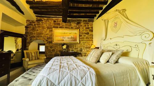 a bedroom with a bed and a stone wall at Residenza Teatro Antico in Todi