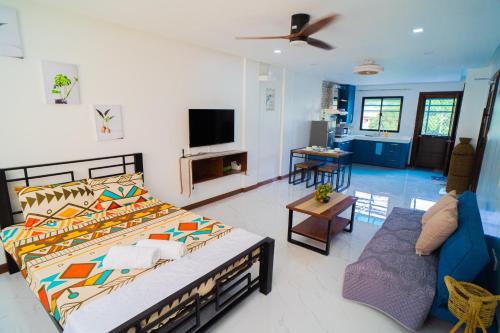 a bedroom with a bed and a living room at LacambraHills Olongapo in Olongapo
