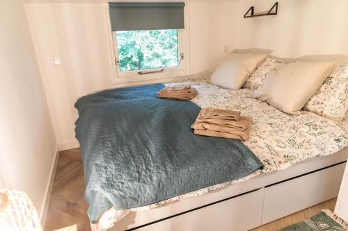 a bed in a small room with towels on it at Fenna's Holiday Home in Exloo
