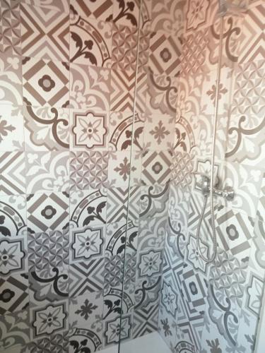 a bathroom with a shower with a tile wall at Sylhet BNB in Lisbon