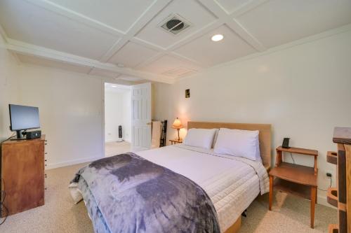 1 dormitorio con 1 cama grande y TV en Charming Great Cacapon Cabin with Screened-In Porch!, en Morton Grove