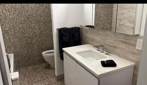 a bathroom with a white sink and a toilet at Large 3 bedroom in Flatiron in New York