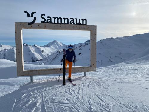 a person on skis standing in front of a sign at Apart Jil-Marie Studio 7 in Samnaun