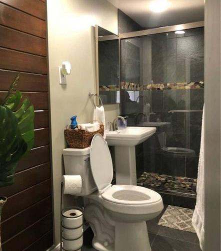 a bathroom with a toilet and a sink at Bonito descanso LAX 10 min SOFI 5 min in Hawthorne