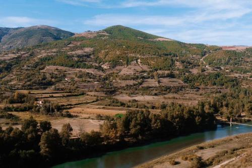 an aerial view of a river with mountains in the background at Mountain Villa in Zall Dardhe in Peshkopi