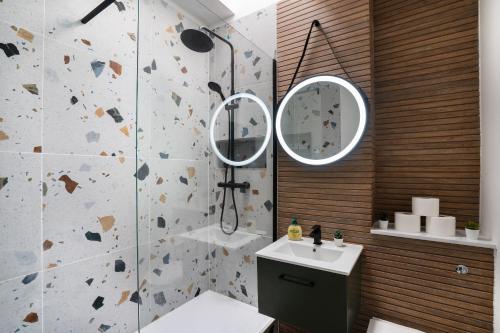 a bathroom with a shower and a sink and a mirror at Luxury Apartment - Portobello in Edinburgh