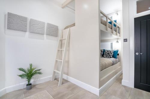 a room with a bed and bunk beds in it at Luxury Apartment - Portobello in Edinburgh