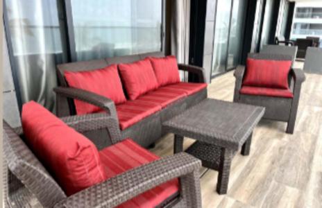 a living room with a red couch and chairs at Kololi Sands Apartment 607 in Sere Kunda