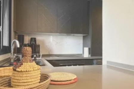 a kitchen with a counter top with a basket of food at Kololi Sands Apartment 607 in Sere Kunda