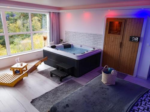 a room with a large tub in the middle of a room at Wellness pod zvezdami, Maribor - PRIVATE in Maribor