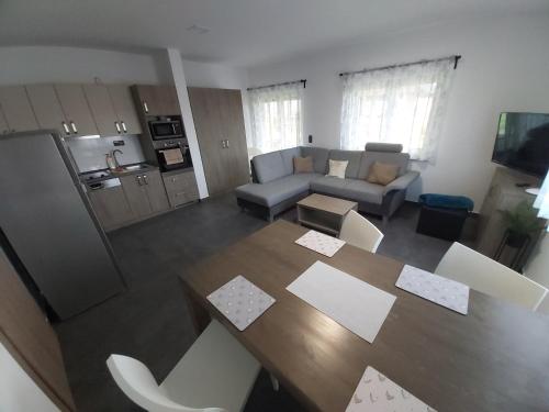 a living room with a table and a couch at APARTMÁNY POD SJEZDOVKOU in Abertamy
