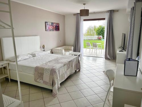 a bedroom with a bed and a television and a patio at Cape House in Albano Laziale