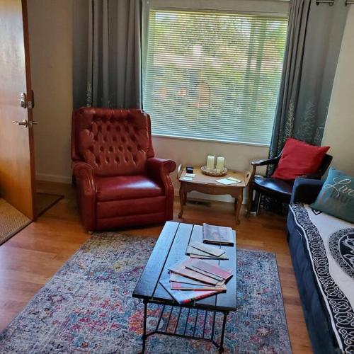 a living room with a couch and chairs and a table at Sweet 2 bedroom close to U of Oregon & track! in Eugene