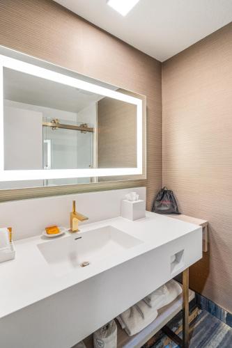 a bathroom with a white sink and a mirror at 3 Palms Tucson North Foothills in Tucson