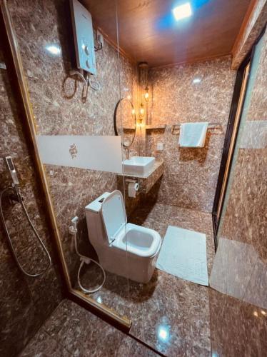 a bathroom with a toilet and a sink at Sandy Heaven Maldives in Gulhi