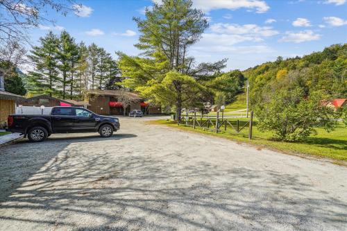 a black truck parked on the side of a road at Cedarbrook Queen Studio 207 in Killington