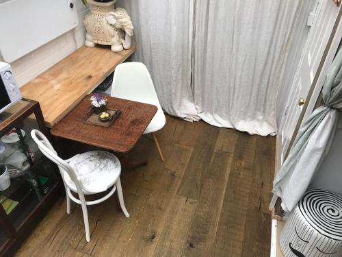 a small table with two chairs and a table with flowers on it at Tiny hideaway in Cambridge in Cambridge