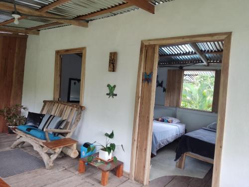 a room with a bed and a chair and a bedroom at Pequeño paraíso Río Celeste in San Rafael