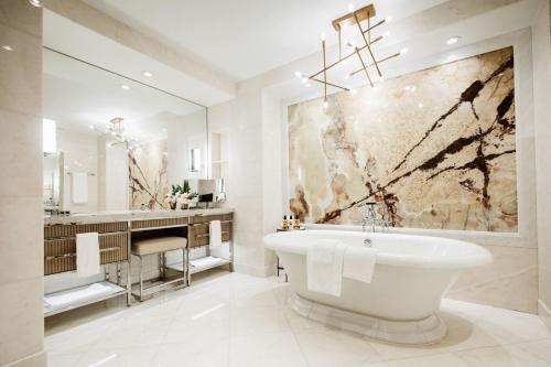 a bathroom with a white tub and a sink at The Ritz-Carlton, Toronto in Toronto