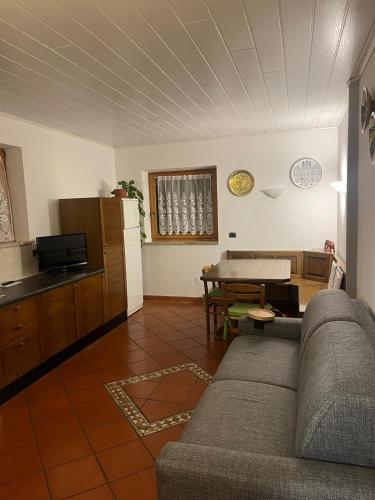 a living room with a couch and a table at Dolomiti Di Brenta in Ronzone