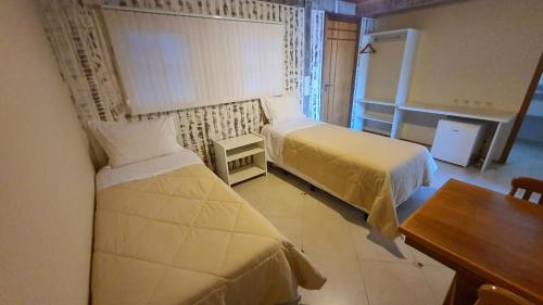 Ein Bett oder Betten in einem Zimmer der Unterkunft Pousada In Garden